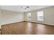 Spacious bedroom with wood flooring, ceiling fan, and bright windows at 3322 Park Branch Ave, Clermont, FL 34711