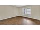 Large bedroom with wood-look floors, neutral walls, and a bright window for natural light at 3322 Park Branch Ave, Clermont, FL 34711