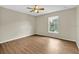 A serene bedroom featuring wood-look floors, neutral walls and a ceiling fan at 3322 Park Branch Ave, Clermont, FL 34711