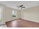 Bedroom with wood flooring, ceiling fan, and natural light from the window at 3322 Park Branch Ave, Clermont, FL 34711