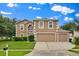 Charming two-story home featuring a three-car garage and well-maintained landscaping at 3322 Park Branch Ave, Clermont, FL 34711