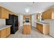 Kitchen with an island, wood cabinets, recessed lighting and stainless-steel appliances at 3322 Park Branch Ave, Clermont, FL 34711