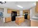 Traditional kitchen with wooden cabinets, black appliances, and tile flooring at 3322 Park Branch Ave, Clermont, FL 34711