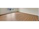 Open living area with wood floors and natural light from the window at 3322 Park Branch Ave, Clermont, FL 34711
