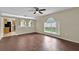 Open-concept living room with wood-look floors, arched entryway, and a view into the kitchen at 3322 Park Branch Ave, Clermont, FL 34711
