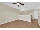 Loft area with wood-look floors, neutral walls, and a door on the right at 3322 Park Branch Ave, Clermont, FL 34711