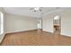 Bright main bedroom with wood flooring, en suite bathroom access, and a ceiling fan at 3322 Park Branch Ave, Clermont, FL 34711