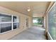 Covered patio featuring neutral paint, concrete flooring, and screen enclosure overlooking the backyard at 3322 Park Branch Ave, Clermont, FL 34711