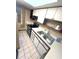 The kitchen features tile flooring, bright countertops, and a stainless steel double sink at 333 Lake Howard Nw Dr # 201A, Winter Haven, FL 33880