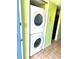 A stackable white washer and dryer set in a small laundry area at 333 Lake Howard Nw Dr # 201A, Winter Haven, FL 33880