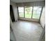 Enclosed, tiled sun room with large windows providing expansive views and natural light at 333 Lake Howard Nw Dr # 201A, Winter Haven, FL 33880