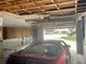 Garage features a red car, overhead storage cabinets, and an automatic door opener at 3695 Dale Ct, Mount Dora, FL 32757