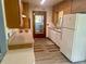 Well-lit kitchen with vintage appliances, countertops, and wood cabinets ready for updates at 3695 Dale Ct, Mount Dora, FL 32757