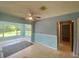 Open-concept living room features a sunroom and adjacent hallway leading to the bedrooms at 3695 Dale Ct, Mount Dora, FL 32757