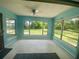 Enclosed sunroom with windows on three walls provides abundant natural light and views of the yard at 3695 Dale Ct, Mount Dora, FL 32757