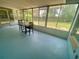 Enclosed sunroom featuring a table with chairs and large windows offering views of the backyard at 3695 Dale Ct, Mount Dora, FL 32757