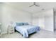 Bedroom with neutral walls, a fan, and hardwood-style floors, perfect for relaxation at 3964 Mayhill Loop, Eustis, FL 32736