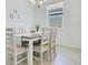 Bright dining room with decorative lighting, neutral decor, and a large window at 3964 Mayhill Loop, Eustis, FL 32736