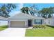 Charming single-story home with a well-manicured lawn, two car garage, and inviting front entrance at 3964 Mayhill Loop, Eustis, FL 32736