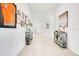 Inviting hallway featuring neutral paint, console tables with decor, and artwork lining the walls at 3964 Mayhill Loop, Eustis, FL 32736