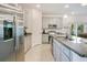 Modern kitchen featuring stainless steel appliances, granite countertops, and ample storage space at 3964 Mayhill Loop, Eustis, FL 32736