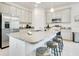 Bright kitchen with granite counters, stainless appliances, and an island with seating at 3964 Mayhill Loop, Eustis, FL 32736