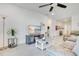Cozy living room features a comfortable sofa, TV, ceiling fan, and ample natural light at 3964 Mayhill Loop, Eustis, FL 32736