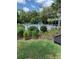 Community pool area with a splash pad, lush landscaping, black aluminum fencing and a covered gazebo at 406 Cool Summer Ln, Davenport, FL 33837