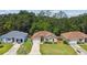 Aerial view of a well-maintained home with a landscaped front yard, set in a tranquil neighborhood at 419 Cierra Oaks Cir, Lady Lake, FL 32159