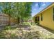 Large backyard featuring partial grass, a wood privacy fence, and partial shade from trees at 419 Cierra Oaks Cir, Lady Lake, FL 32159