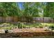 Landscaped backyard featuring a brick patio and wood privacy fence, perfect for outdoor relaxation at 419 Cierra Oaks Cir, Lady Lake, FL 32159
