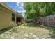 Home's backyard with partial grass coverage, utility line, and wood privacy fence at 419 Cierra Oaks Cir, Lady Lake, FL 32159
