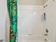 Bathroom features tiled walls, a bathtub and shower combination at 419 Cierra Oaks Cir, Lady Lake, FL 32159