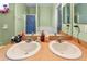 Bathroom featuring a double sink vanity and a large mirror at 419 Cierra Oaks Cir, Lady Lake, FL 32159