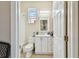 Well lit bathroom featuring a white vanity, mirror, toilet and tiled flooring at 419 Cierra Oaks Cir, Lady Lake, FL 32159
