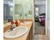 Bathroom with a double vanity, large mirror, and access to the bedroom at 419 Cierra Oaks Cir, Lady Lake, FL 32159