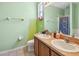 Bathroom features a double sink and a shower with patterned shower curtain at 419 Cierra Oaks Cir, Lady Lake, FL 32159