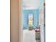 A light blue bedroom with a ceiling fan and a large window at 419 Cierra Oaks Cir, Lady Lake, FL 32159