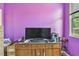 Bedroom featuring purple walls and a modern flat screen television at 419 Cierra Oaks Cir, Lady Lake, FL 32159