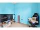 Bright blue bedroom featuring a large flat screen television and gaming chair at 419 Cierra Oaks Cir, Lady Lake, FL 32159