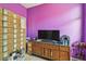 Purple room featuring a dresser and a flat screen television at 419 Cierra Oaks Cir, Lady Lake, FL 32159