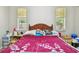 Bedroom featuring two windows and comfortable furnishings at 419 Cierra Oaks Cir, Lady Lake, FL 32159