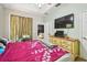 Comfortable bedroom with natural light, plus a dresser with a television at 419 Cierra Oaks Cir, Lady Lake, FL 32159