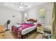 Comfortable bedroom with ceiling fan and two windows at 419 Cierra Oaks Cir, Lady Lake, FL 32159