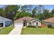 Charming single-story home with well-maintained lawn, inviting entrance, and attached garage at 419 Cierra Oaks Cir, Lady Lake, FL 32159