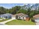 Well-manicured front yard highlights this single-story home with attached garage and inviting entrance at 419 Cierra Oaks Cir, Lady Lake, FL 32159