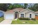 Inviting single-story home features a well-kept lawn, an attached garage, and a neatly maintained exterior at 419 Cierra Oaks Cir, Lady Lake, FL 32159