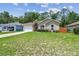 A delightful single-story residence boasts lush front yard and attached garage at 419 Cierra Oaks Cir, Lady Lake, FL 32159