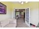 Relaxing living room showcasing the carpet flooring, a sofa, and French doors at 419 Cierra Oaks Cir, Lady Lake, FL 32159
