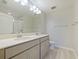 Bathroom with double sinks, a large mirror, and modern fixtures at 463 Cape Honeysuckle Pl, Sanford, FL 32771